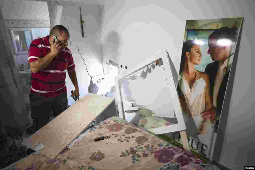 Avihai Jorno inspects the damage to his home after a rocket fired by Palestinian militants in Gaza landed in the southern town of Sderot, July 3, 2014.
