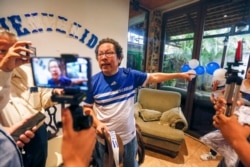 FILE - Nicaraguan journalist Miguel Mora speaks to the press after his release from prison, at his home in Managua, Nicaragua, June 11, 2019.