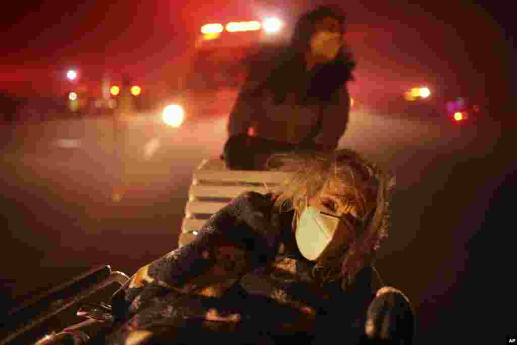 A resident of a senior center is evacuated as the Eaton Fire approaches, Jan. 7, 2025, in Altadena, California.