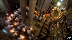 Christian clergymen hold candles during the Easter Sunday procession at the Church of the Holy Sepulcher, traditionally believed by many to be the site of the crucifixion and burial of Jesus Christ, in Jerusalem's Old City, April 20, 2014.