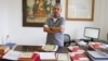 Youk Chhang, director of Documentation Center of Cambodia, stand with classified-document from the Australian External (Foreign) Affairs Department, on September 22, 2015. (NeouVannarin/VOA Khmer)