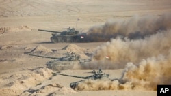 Tank-tank Tajikistan saat latihan militer bersama dengan Rusia dan Uzbekistan di lapangan tembak Harb-Maidon sekitar 20 kilometer utara perbatasan Tajikistan dengan Afghanistan, di Tajikistan, Selasa, 10 Agustus 2021. (Foto: AP)