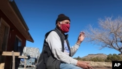 Raymond Clark sits outside his home in Teesto, Ariz., on the Navajo Nation on Feb. 11, 2021. 