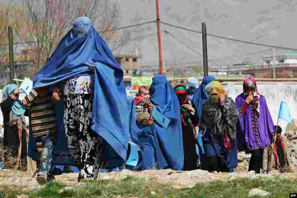 Supporters of Afghan presidential candidate Abdullah Abdullah arrive for an election gathering in Charikar. Afghanistan's April 5 election is the third presidential poll since the fall of the Taliban with 11 candidates contesting the polls.
