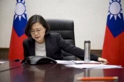 FILE - In this Dec. 2, 2016 photo released by Taiwan Presidential Office, Dec. 3, 2016, Taiwan's President Tsai Ing-wen speaks with U.S. President-elect Donald Trump through a speaker phone in Taipei, Taiwan.