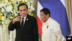 Philippine President Rodrigo Duterte, right, and Thailand's Prime Minister Prayuth Chan-ocha walk together as they leave a joint news conference at the government house in Bangkok, Thailand, March 21, 2017. Duterte is in Thailand for a two-day visit, rounding out his southeast Asia tour.