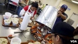 FILE - Mexican workers, on the U.S. H2B visa program for seasonal guest workers, process crabs at the A.E. Phillips & Son Inc. crab-picking house on Hooper's Island in Fishing Creek, Maryland, Aug. 26, 2015. 