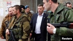 FILE - Head of the self-proclaimed Donetsk people's republic Alexander Zakharchenko (C) is seen surrounded by bodyguards in Donetsk, eastern Ukraine, Nov. 14, 2014.