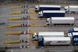 FILE - British soldiers test truck drivers for the coronavirus disease before entering the Port of Dover, Britain, Dec. 26, 2020.