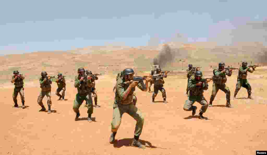 Security forces loyal to Syria's President Bashar al-Assad take part in a field exercise at an undisclosed location, May 22, 2013. (SANA via Reuters)