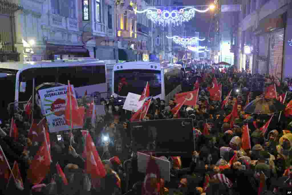 Supporters of Turkey's President Recep Tayyip Erdogan wave flags outside the Dutch consulate to protest, in Istanbul, March 12, 2017.