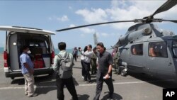 Medical officers prepare a sample for loading on to a helicopter for testing in Sihanoukville, Cambodia, Feb. 13, 2020. The Westerdam cruise ship anchored Thursday off Cambodia for health checks.