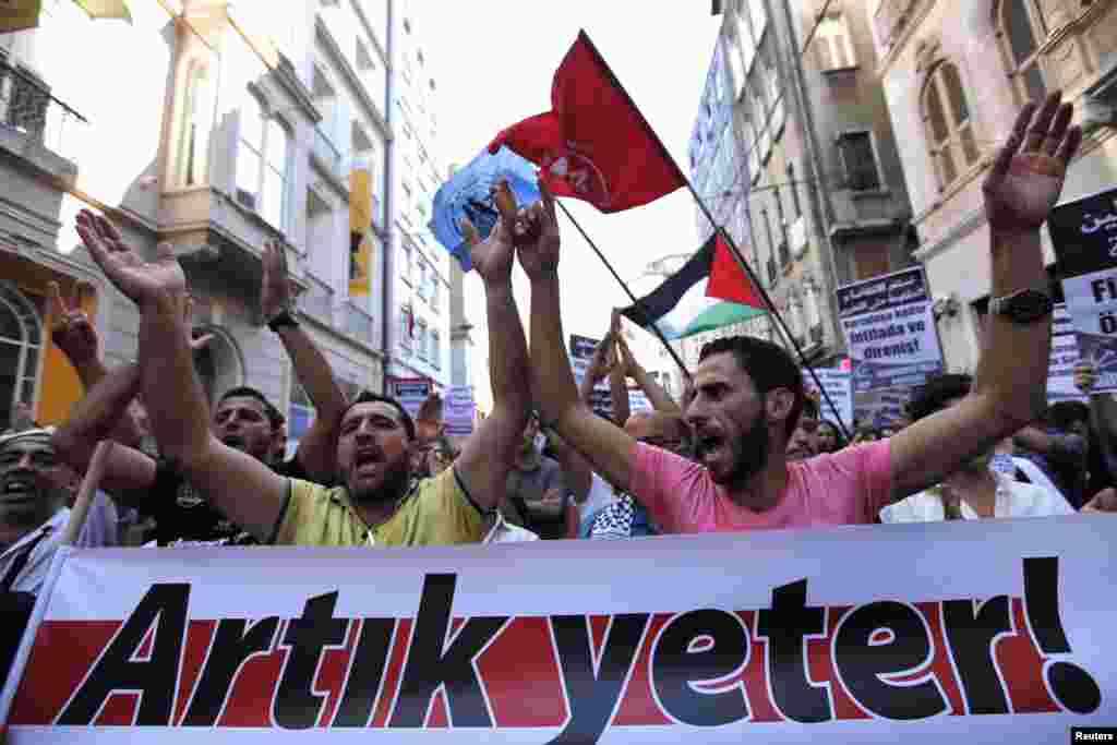 Pro-Palestinian demonstrators hold a banner that reads "Enough is Enough" referring to Israeli military strikes on Gaza, central Istanbul, July 13, 2014.