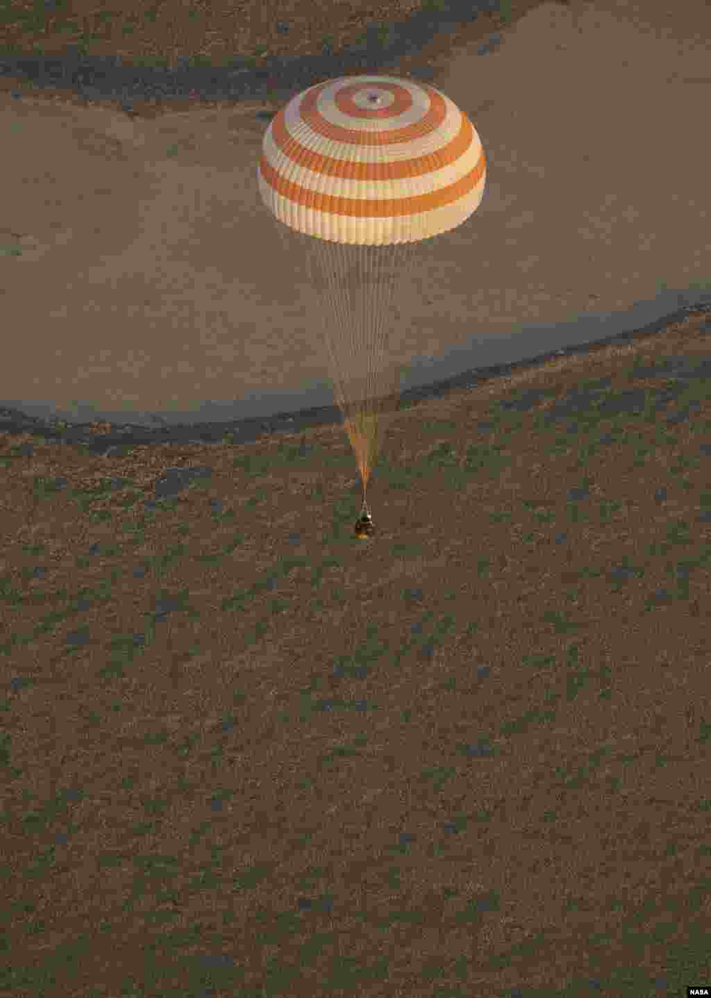 The Soyuz TMA-09M is seen moments before it lands southeast of the town of Zhezkazgan, Kazakstan with the crew of Expedition 37. Expedition 37 Commander Fyodor Yurchikhin of the Russian Federal Space Agency (Roscosmos), Flight Engineer Karen Nyberg of NASA and Flight Engineer Luca Parmitano of the European Space Agency are returning to Earth after five and a half months on the International Space Station.