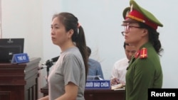 Prominent blogger Nguyen Ngoc Nhu Quynh, left, stands trial in the south central province of Khanh Hoa, Vietnam, June 29, 2017. 
