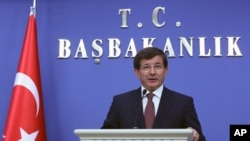 Turkey's new Prime Minister Ahmet Davutoglu announces his cabinet ministers in Ankara, Aug. 29, 2014.