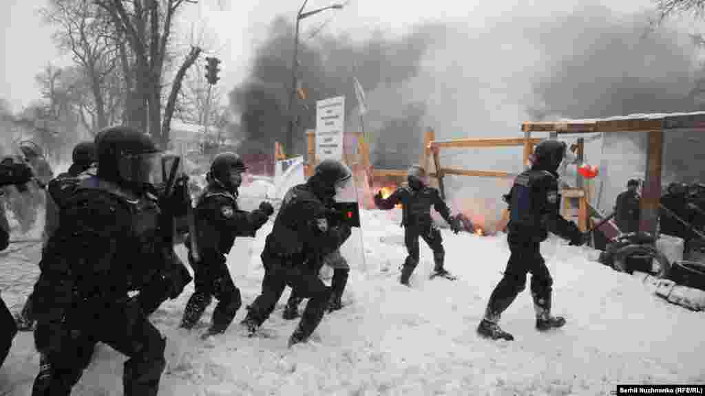 Riot police remove a tent camp set up last October by supporters of Mikheil Saakashvili, who are demanding President Petro Poroshenko resign, detaining over 100 people, in Kyiv, Ukraine, March 3, 2018.