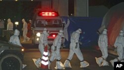 Medical staff arrive at Fukushima Medical University Hospital to treat radiation exposed workers from Tokyo Electric Power Co.'s Fukushima Daiichi Nuclear Power Plant, Fukushima City, Japan, March 24, 2011.