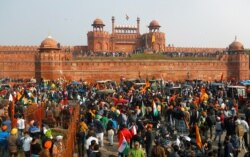 Farmers gather in front of the historic Red Fort during a protest against farm laws introduced by the government, in Delhi, India, Jan. 26, 2021.