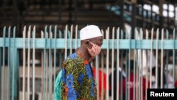 FILE - A man wearing a protective face mask is seen on the first day of the easing of coronavirus lockdown measures, in Lagos, Nigeria, May 4, 2020.