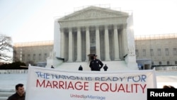 Supporters of gay marriage hold a banner as they rally in front of the Supreme Court in Washington March 27, 2013. 