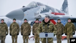 Ukrainian President Petro Poroshenko addresses the Armed Forces of Ukraine at the military airfield in Vasylkiv region, Ukraine, Dec. 1, 2018, as Poroshenko transferred new aircraft and military equipment to the Ukrainian Armed Forces.