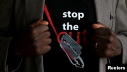 FILE - A man's T-shirt reads "Stop the Cut," referring to female genital mutilation, during a social event advocating against such practices at a school for girls in Imbirikani, Kenya, April 21, 2016.