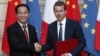 President of Airbus Commercial Aircraft, Guillaume Faury, and Chairman of China Aviation Supplies Co., Jia Baojun, shake hands during an agreement signing ceremony at the Elysee Palace in Paris, March 25, 2019. 