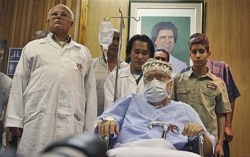 FILE - Libyan Abdel Baset al-Megrahi, who was found guilty of the 1988 Lockerbie bombing but released from his Scottish prison on compassionate grounds, is seen below a portrait of Libyan Leader Moammar Gadhafi, Sept. 9, 2009.