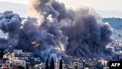 Smoke billows from the site of several explosions during an Israeli raid on the Jenin camp for Palestinian refugees on Feb. 2, 2025.