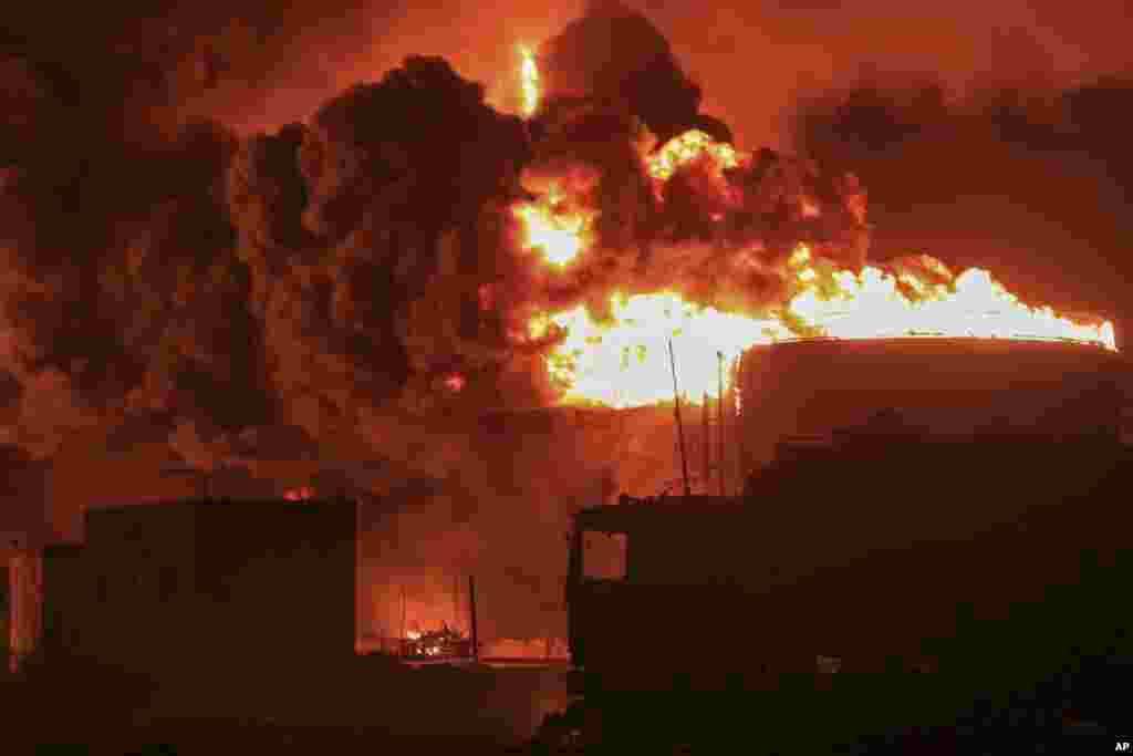 Oil tanks burn at the port in Hodeidah, Yemen, July 20, 2024. The Israeli army said it has struck several Houthi targets in western Yemen following a fatal drone attack by the rebel group in Tel Aviv the previous day. 
