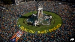 Protesters hold esteladas or independence flags as they take part in a demonstration during the Catalan National Day in Barcelona, Spain, Sept. 11, 2019. 