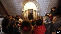 Catholic pilgrims pray at the entrance of the Grotto at the Church of Nativity, traditionally believed by Christians to be the birthplace of Jesus Christ, in the West Bank town of Bethlehem (file photo)