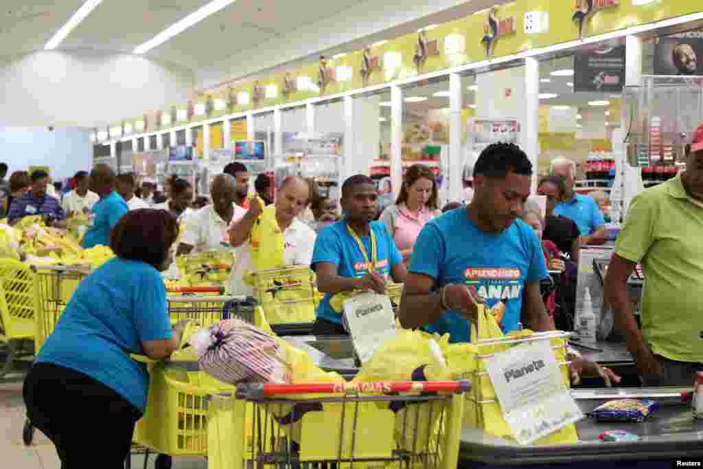 People buy groceries at a local supermarket in Santo Domingo, Dominican Republic, as Hurricane Irma slams across islands in the northern Caribbean, Sept. 6, 2017.