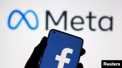A smartphone with Facebook's logo is seen in front of displayed Facebook's new rebrand logo Meta in this illustration taken Oct. 28, 2021. Meta also owns Instagram.