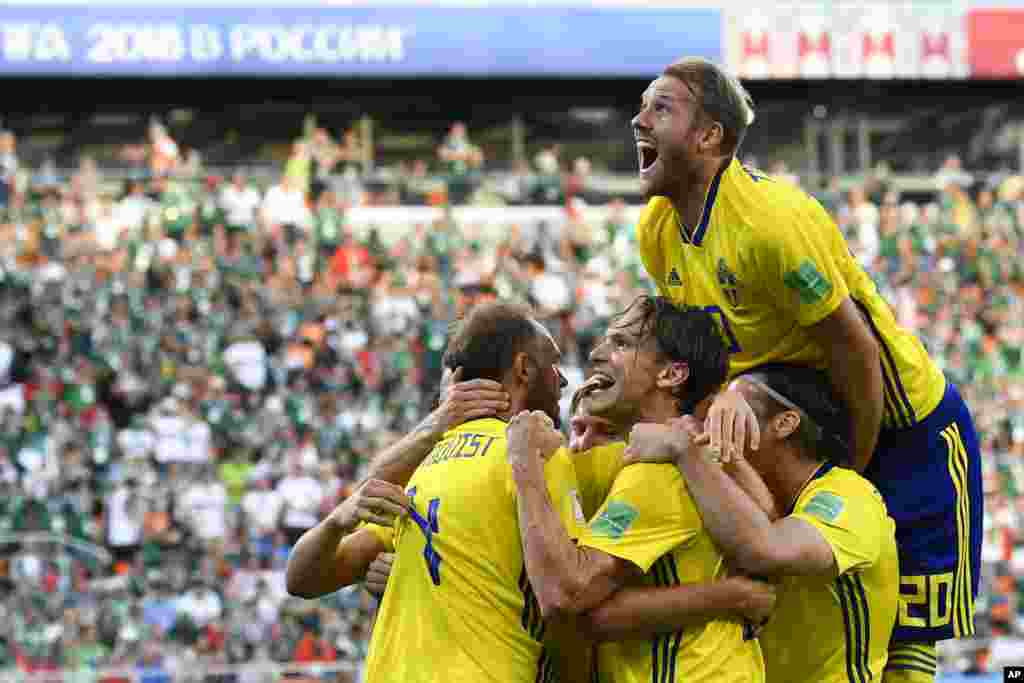 Sweden's Andreas Granqvist, left, celebrates with teammates after scoring his side's second goal during the group F match between Mexico and Sweden, at the 2018 soccer World Cup in the Yekaterinburg Arena in Yekaterinburg, Russia.