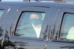 FILE - President Donald Trump drives past supporters gathered outside Walter Reed National Military Medical Center in Bethesda, Md., Oct. 4, 2020.