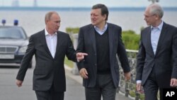 Russian President Vladimir Putin, left, European Commission President Jose Manuel Barroso, center, and European Council President Herman Van Rompuy walk during the Russia EU Summit outside St.Petersburg, Russia, Sunday, June 3, 2012. 