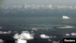 FILE - An aerial photo taken though the window of a Philippine military plane shows the land reclamation by China on Mischief Reef in the Spratly Islands in the South China Sea, west of Palawan, Philippines, May 11, 2015.