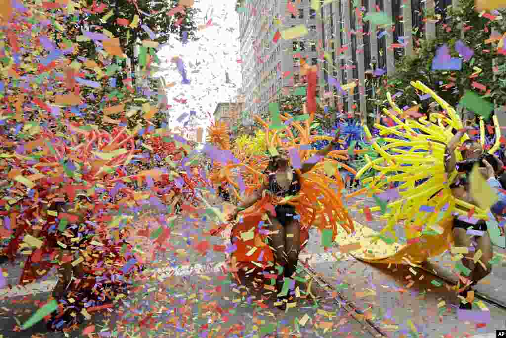 Confetti falls over SF Balloon Magic marchers during the Pride parade in San Francisco, June 25, 2017.