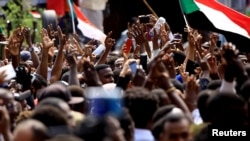 Sudanese demonstrators attend a protest calling for the appointment of top judicial officials and justice for killed demonstrators, outside the presidential palace in Khartoum in Khartoum, Sudan, Sept. 12, 2019. 