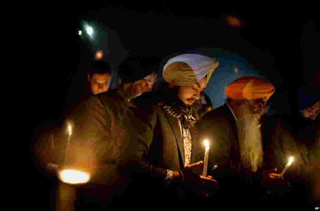 Varinder Singh, of the Queens borough of New York, joins a group of Sikhs from around the Northeastern U.S., in a moment of prayer as a memorial service is broadcast over a loudspeaker outside Newtown High School, December 16, 2012.