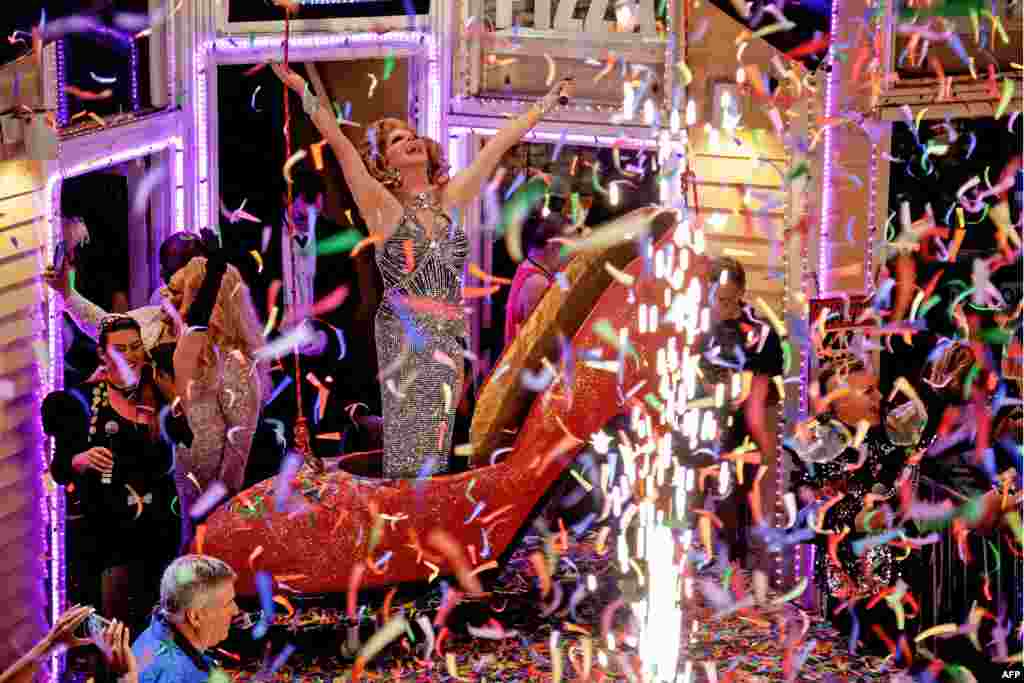 This handout image released by the Florida Keys News Bureau shows female impersonator Christopher Peterson, the star of the New Year's Eve "Red Shoe Drop," celebrating the beginning of the new year on Jan. 1, 2024, in Key West, Fla.