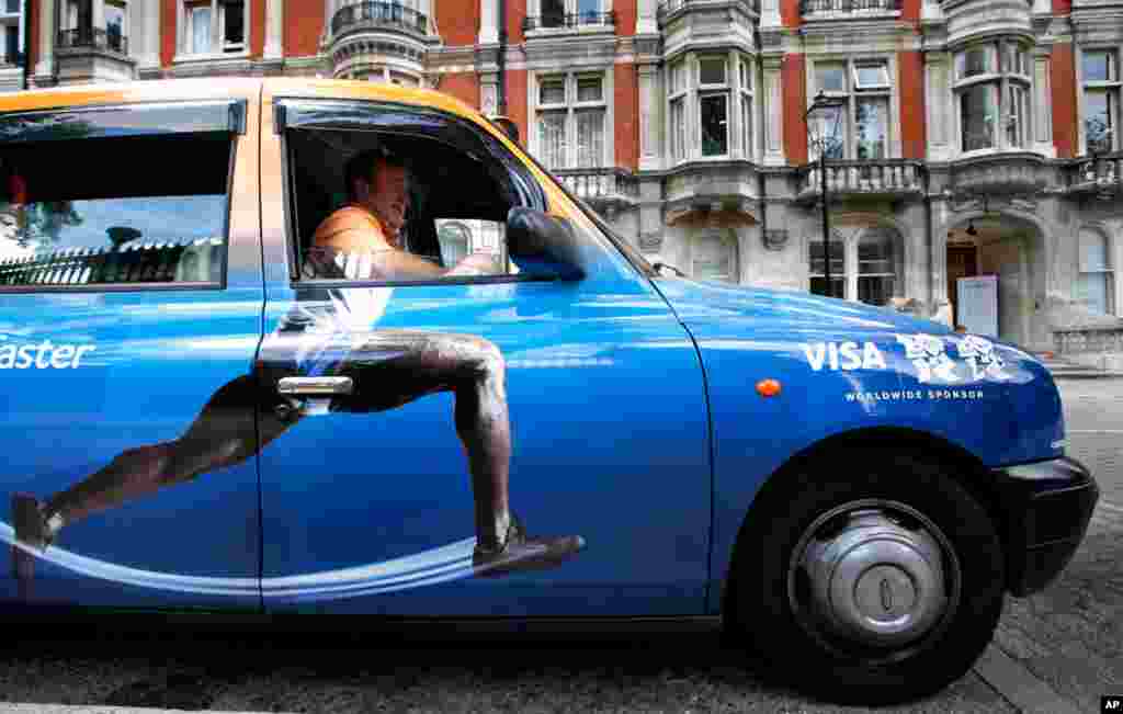 Taxi driver Richard Meid waits in front of the British Museum in London during the Olympics.