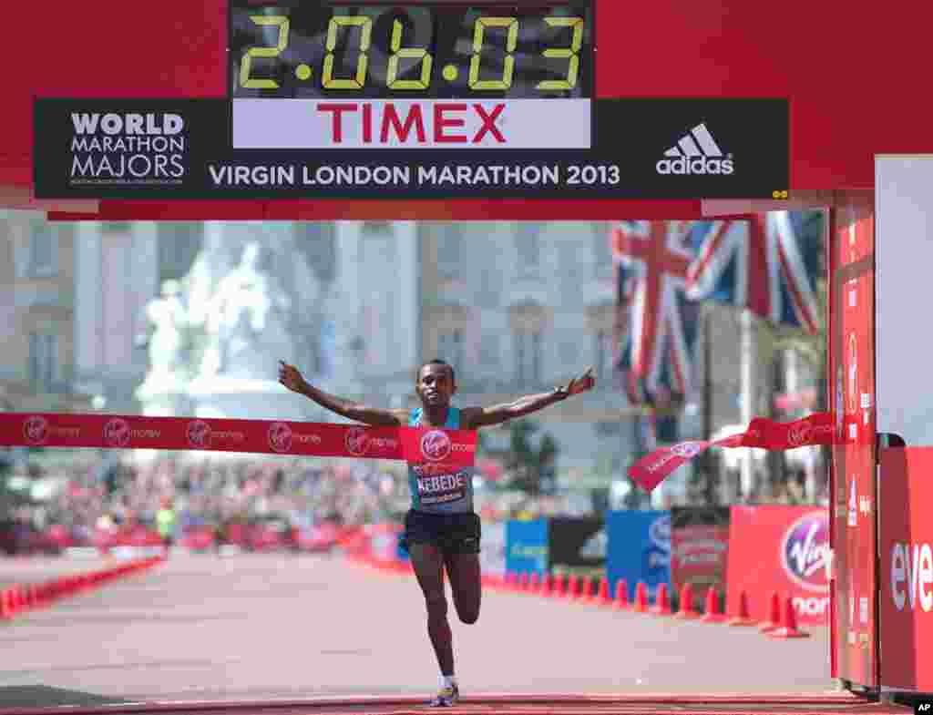 Tsegaye Kebede of Ethiopia crosses the line to win the men's London Marathon, April 21, 2013. A defiant, festive mood prevailed in London, despite concerns raised by the recent attacks on the Boston Marathon.