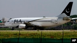 FILE - a Pakistani International Airline plane moments before take off from the Benazir Bhutto airport in Islamabad, Pakistan. 