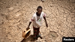FILE - A boy carries a jerrycan in the drought-hit Baligubadle village near Hargeisa, the capital city of Somaliland, in this handout photo provided by The International Federation of Red Cross and Red Crescent Societies, March 15, 2017. 