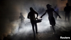 FILE - A worker of the Ministry of Public Health and Population fumigates in the street against mosquito breeding to prevent diseases such as malaria, dengue and Zika in Port-au-Prince, Haiti, on February 15, 2016.
