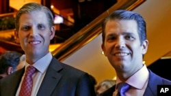Eric Trump, left, and Donald Trump Jr., executive vice presidents of The Trump Organization, pose for a photograph at an event for Scion Hotels, a division of Trump hotels, June 5, 2017, in New York. 
