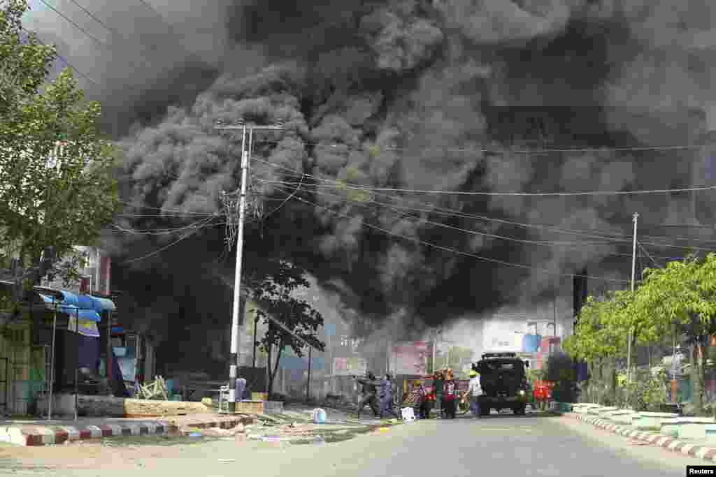 Firemen attempt to extinguish fires during riots in Meikhtila March 22, 2013. 